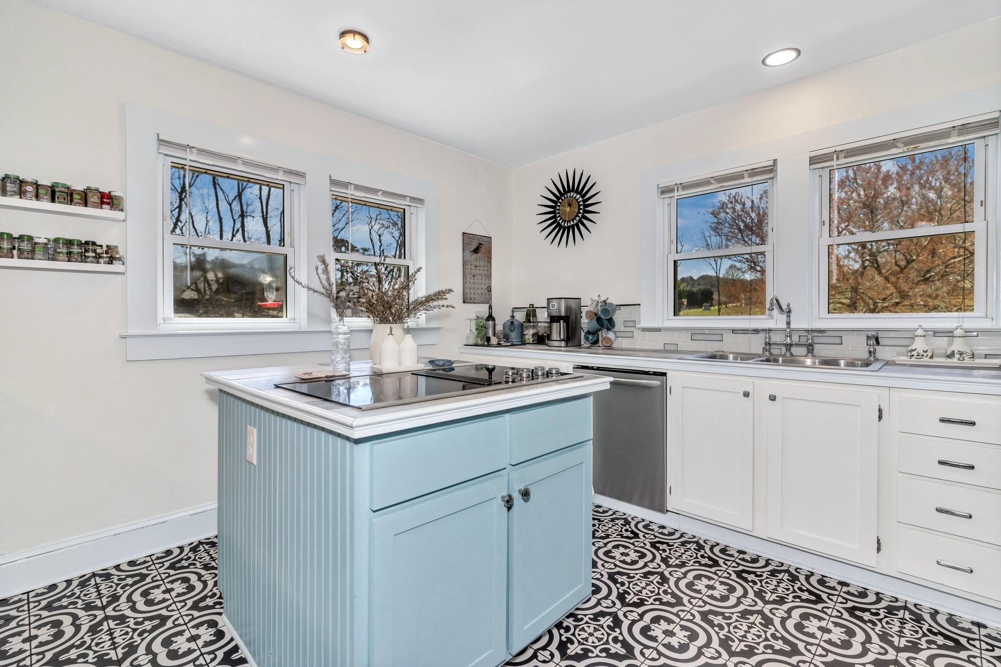 994 Riceville Road Asheville, NC 28805 - Photo 26 of 45 a kitchen with a sink stove and cabinets