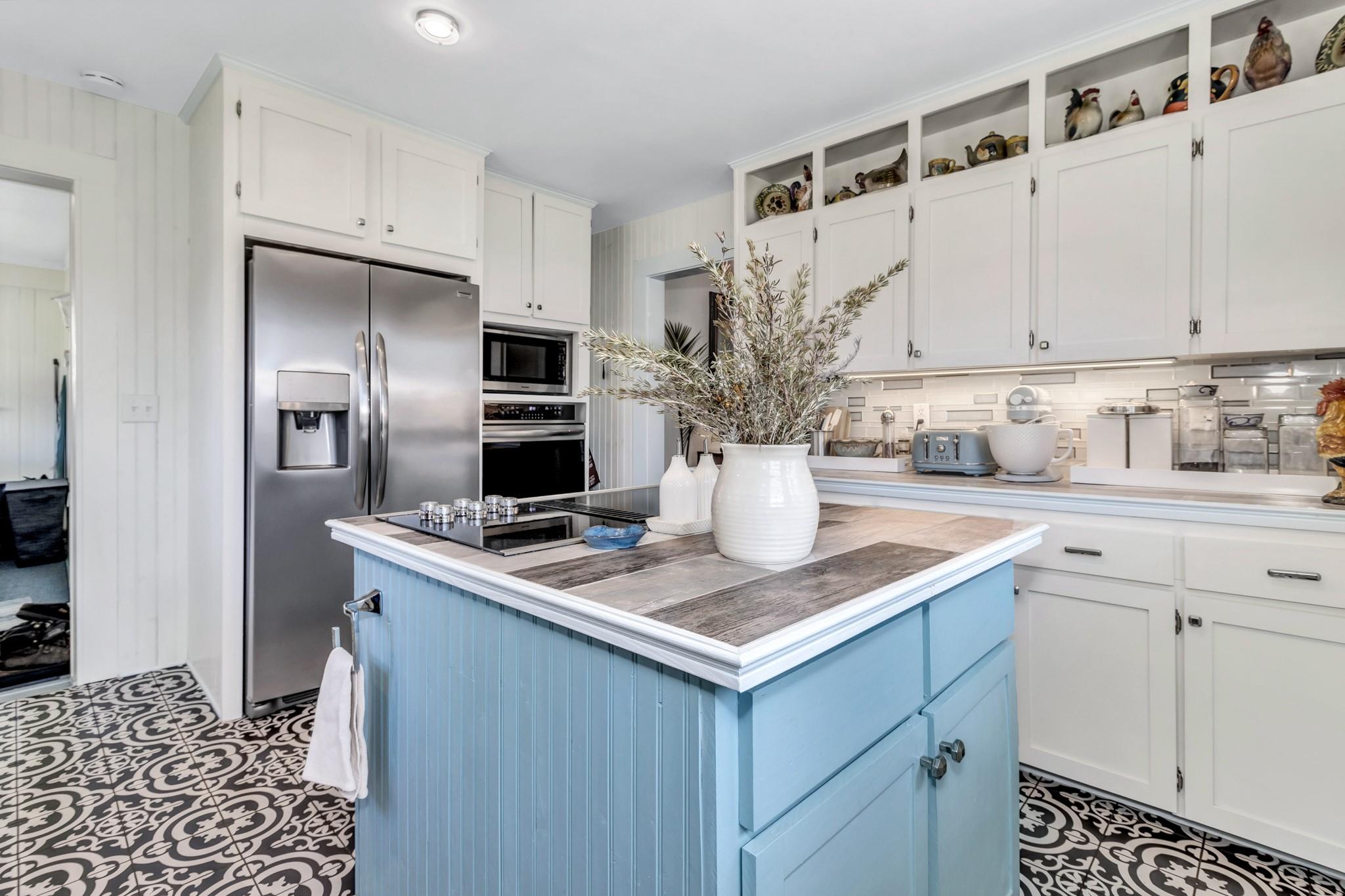 994 Riceville Road Asheville, NC 28805 - Photo 31 of 45 a kitchen with stainless steel appliances kitchen island granite countertop a sink and cabinets