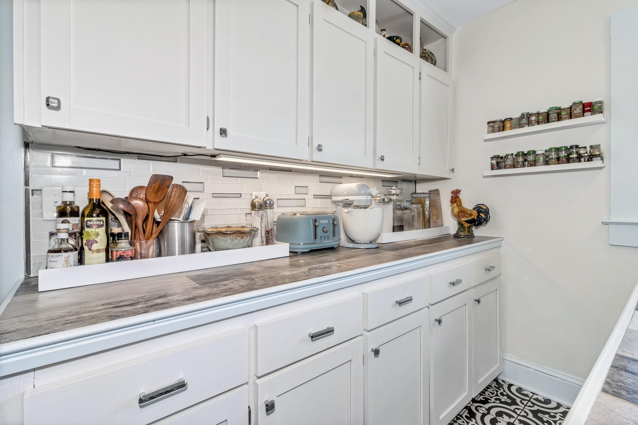 994 Riceville Road Asheville, NC 28805 - Photo 32 of 45 a sink with white cabinets and a wooden floor
