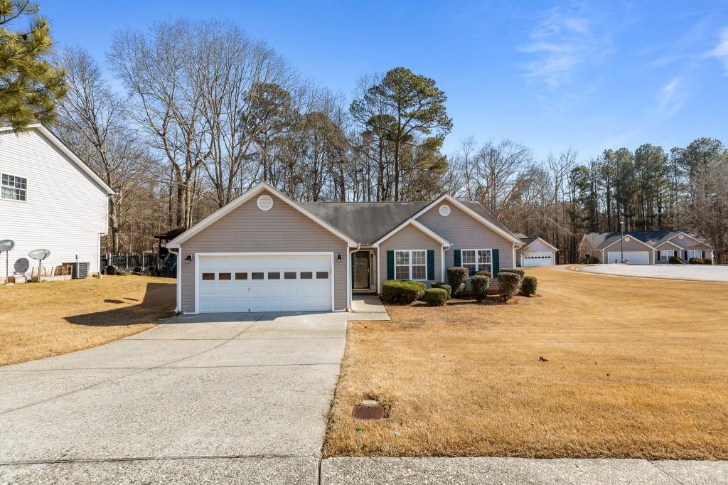 a view of a house with a yard covered in snow