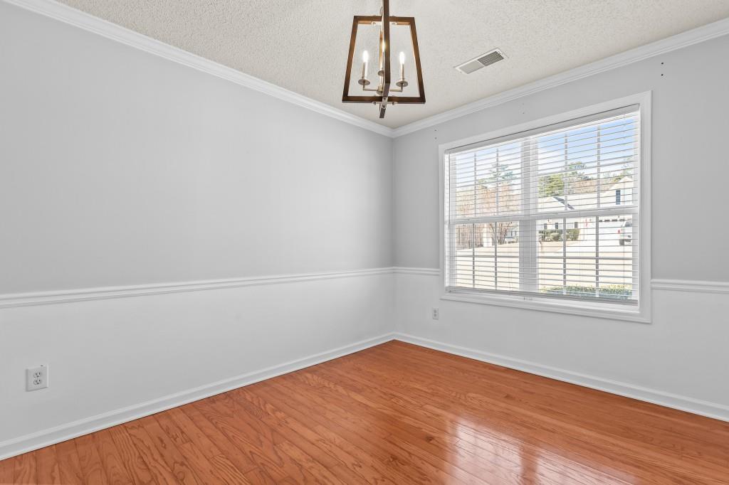 1707 Mountain Fort Way Dacula, GA 30019 - Photo 15 of 34 an empty room with a window and wooden floor