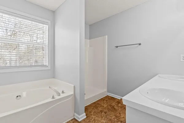 a bathroom with a bathtub and a window