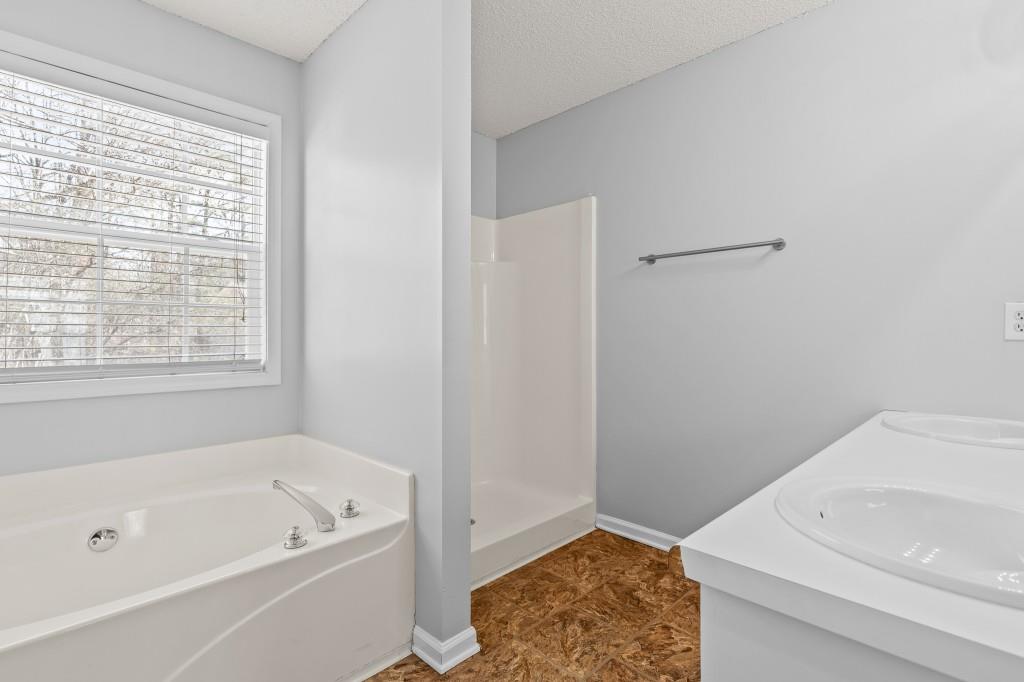 1707 Mountain Fort Way Dacula, GA 30019 - Photo 20 of 34 a bathroom with a bathtub and a window