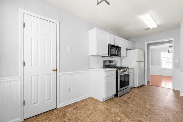 a kitchen with a refrigerator stove and a sink