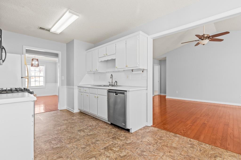1707 Mountain Fort Way Dacula, GA 30019 - Photo 9 of 34 a kitchen with white cabinets and white appliances