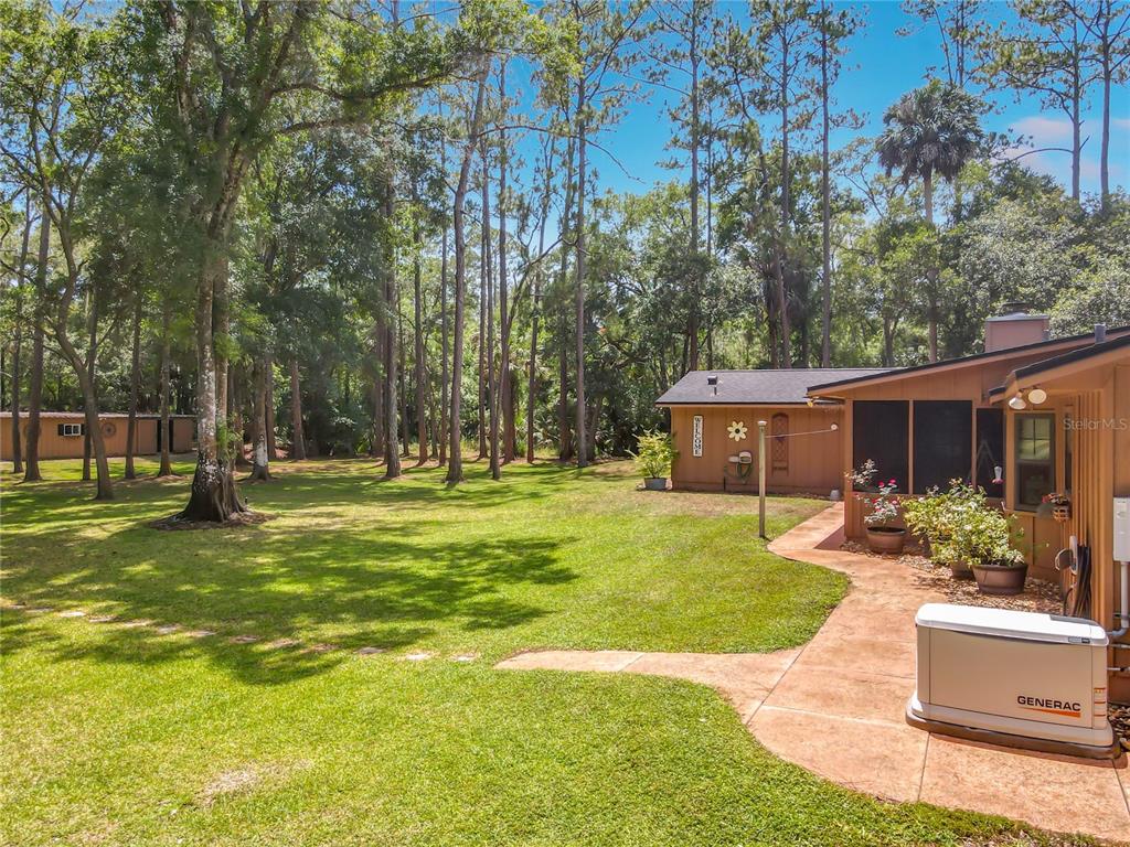1395 Maytown Road Osteen, FL 32764 - Photo 46 of 65 a view of a house with a big yard potted plants and large tree