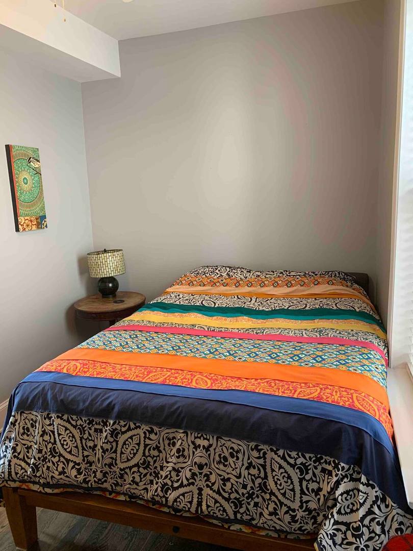 2315 West Thomas Street, Unit 3F Chicago, IL 60622 - Photo 9 of 12 a bed sitting in a bedroom next to a small yard