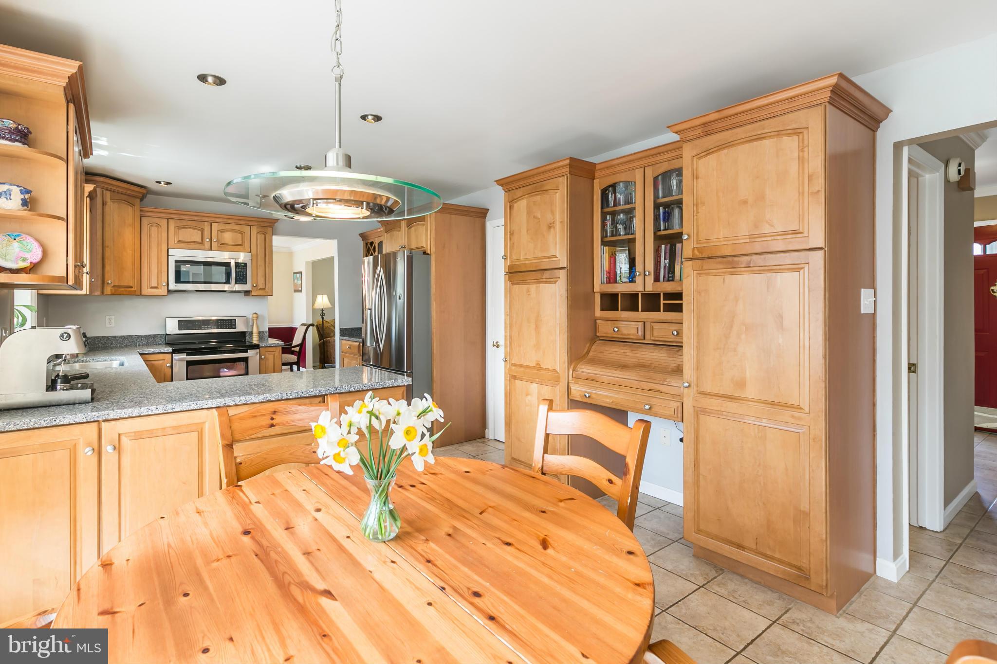 10807 Cross School Road Reston, VA 20191 - Photo 11 of 30 a kitchen with stainless steel appliances granite countertop a refrigerator and a stove top oven