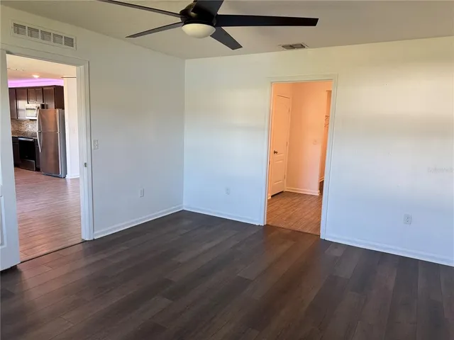 an empty room with wooden floor and closet