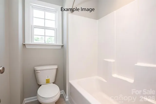 a white toilet sitting next to a bath tub