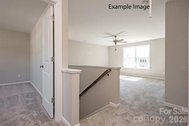 a view of a livingroom with a ceiling fan and window