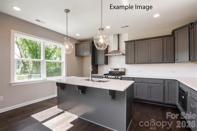 a kitchen with a sink a window and cabinets