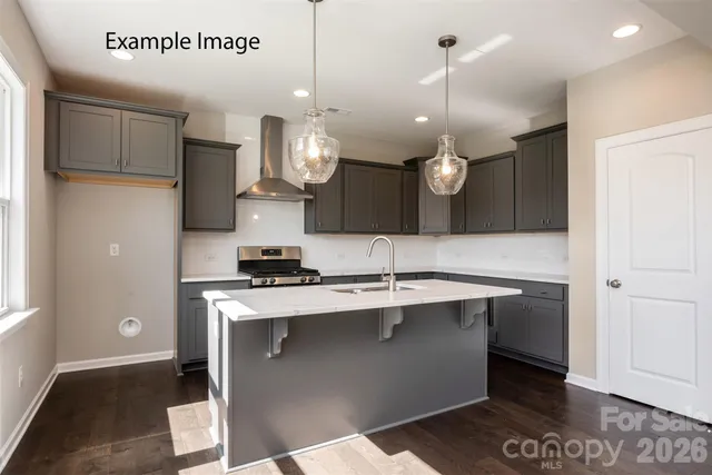 a kitchen with a sink stainless steel appliances and cabinets