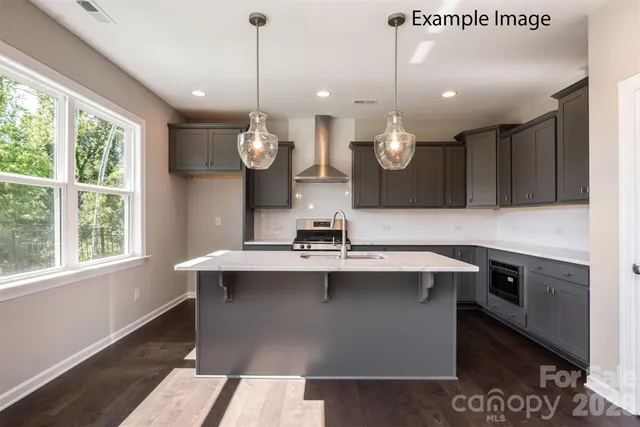 a room with kitchen island a sink and a large window
