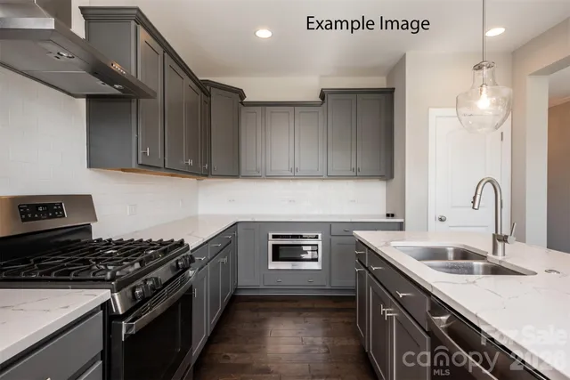 a kitchen that has a sink and a stove top oven