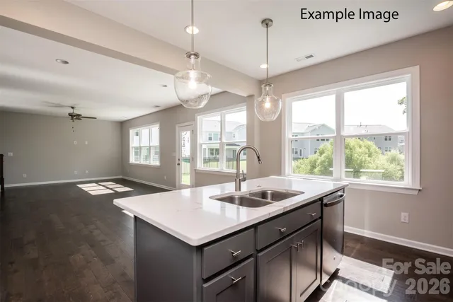 a kitchen with granite countertop sink and window