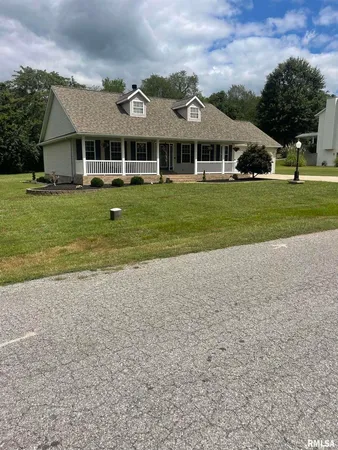 a front view of a residential houses with yard and green space