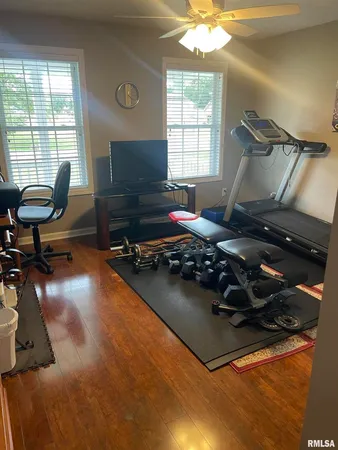 a room with gym equipment and a large window
