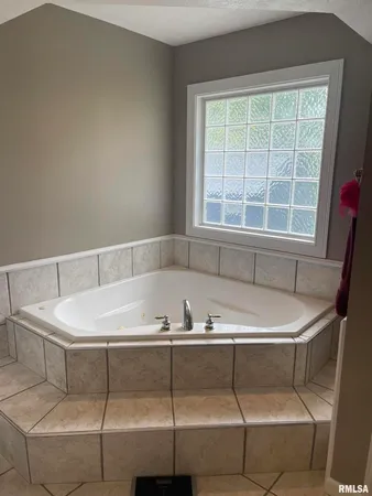 a bath tub sitting next to a window