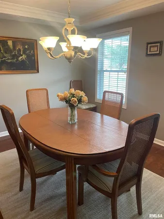 a view of a dining room with furniture and chandelier