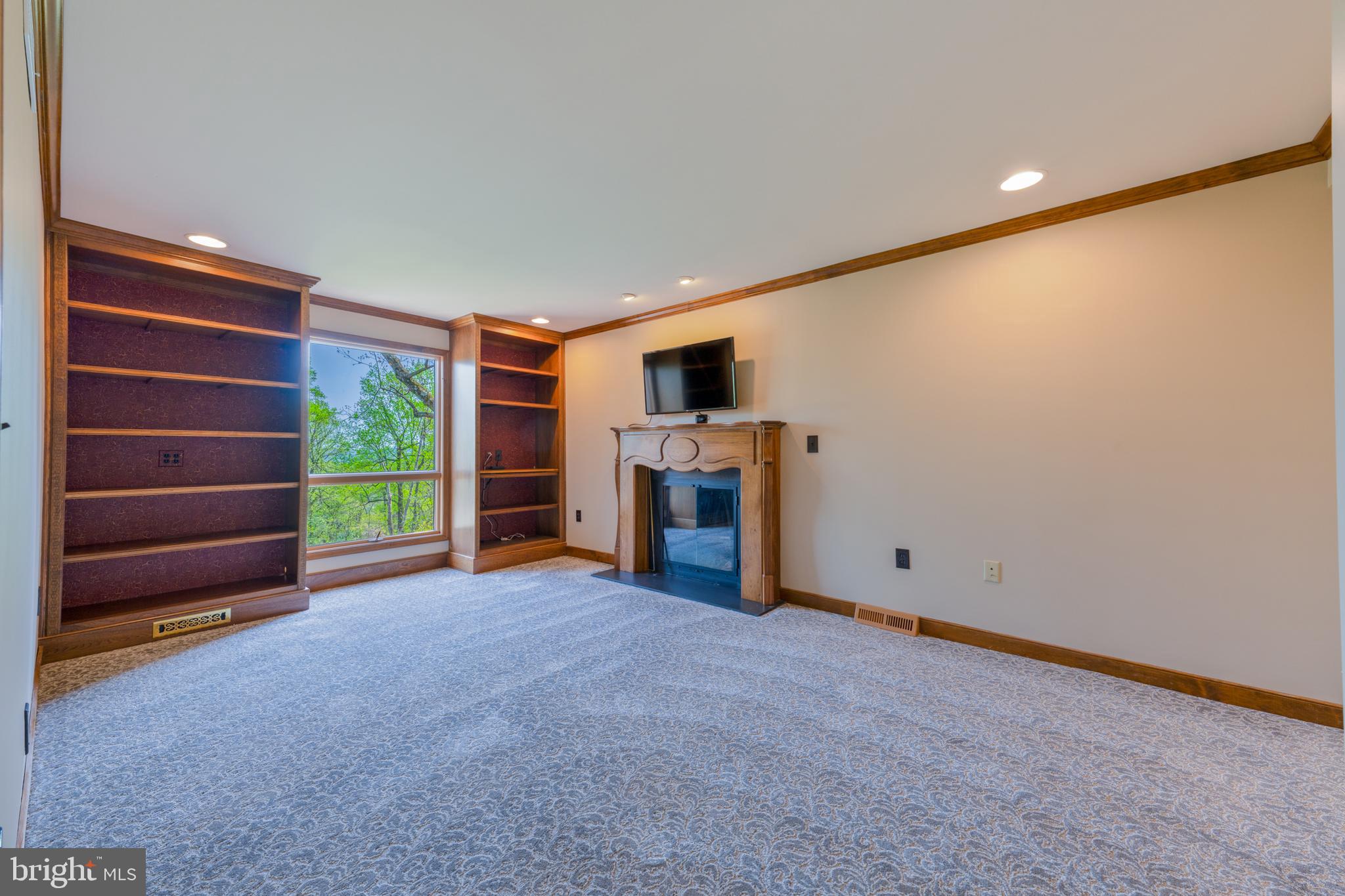 3446 Honeysuckle Road Bethlehem, PA 18015 - Photo 23 of 80 a view of an empty room with a fireplace and a window