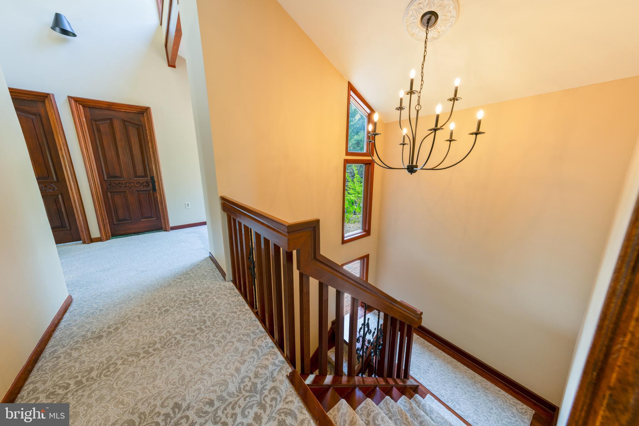 3446 Honeysuckle Road Bethlehem, PA 18015 - Photo 27 of 80 a view of a hallway with wooden floor and stairs