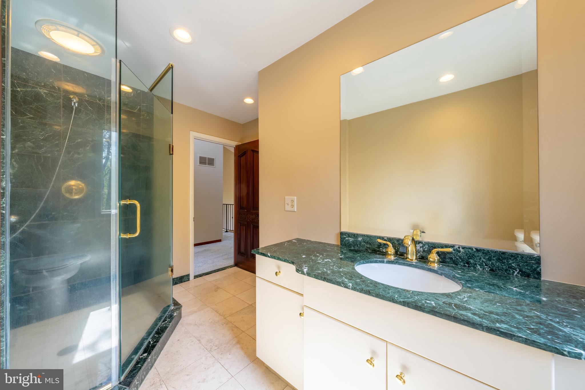 3446 Honeysuckle Road Bethlehem, PA 18015 - Photo 38 of 80 a bathroom with a granite countertop sink and a mirror
