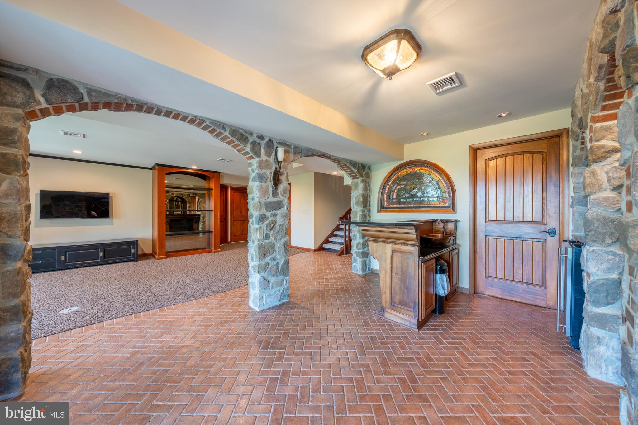 3446 Honeysuckle Road Bethlehem, PA 18015 - Photo 50 of 80 a living room with furniture a flat screen tv and a fireplace