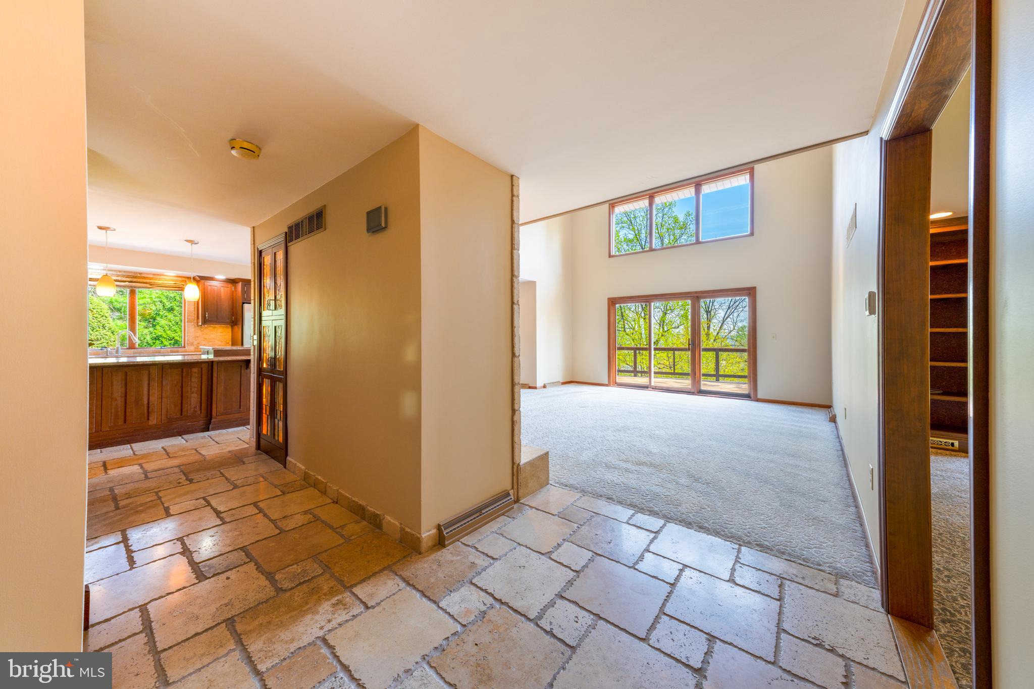 3446 Honeysuckle Road Bethlehem, PA 18015 - Photo 10 of 80 a view of hallway with a door and chandelier