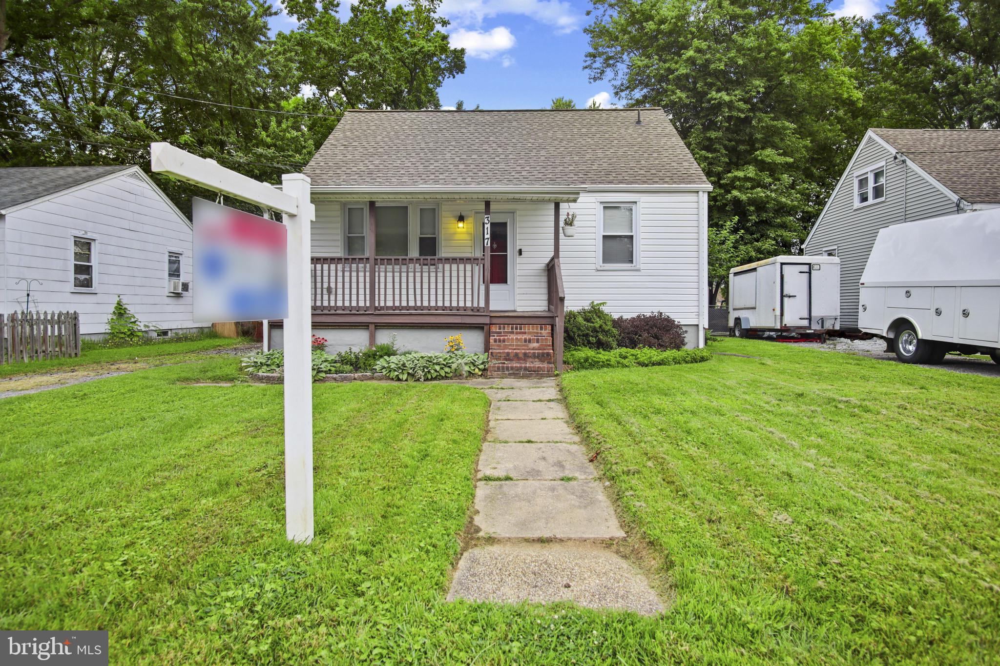 317 Wye Road Essex, MD 21221 - Photo 12 of 35 a front view of a house with a yard and garage