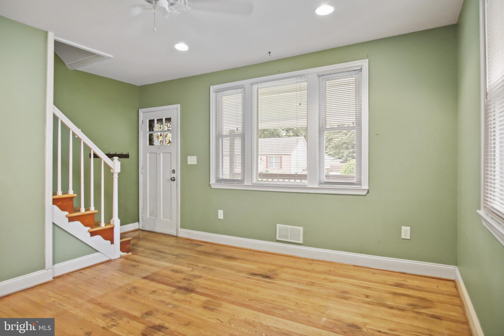 317 Wye Road Essex, MD 21221 - Photo 13 of 35 a view of a room with wooden floor and windows