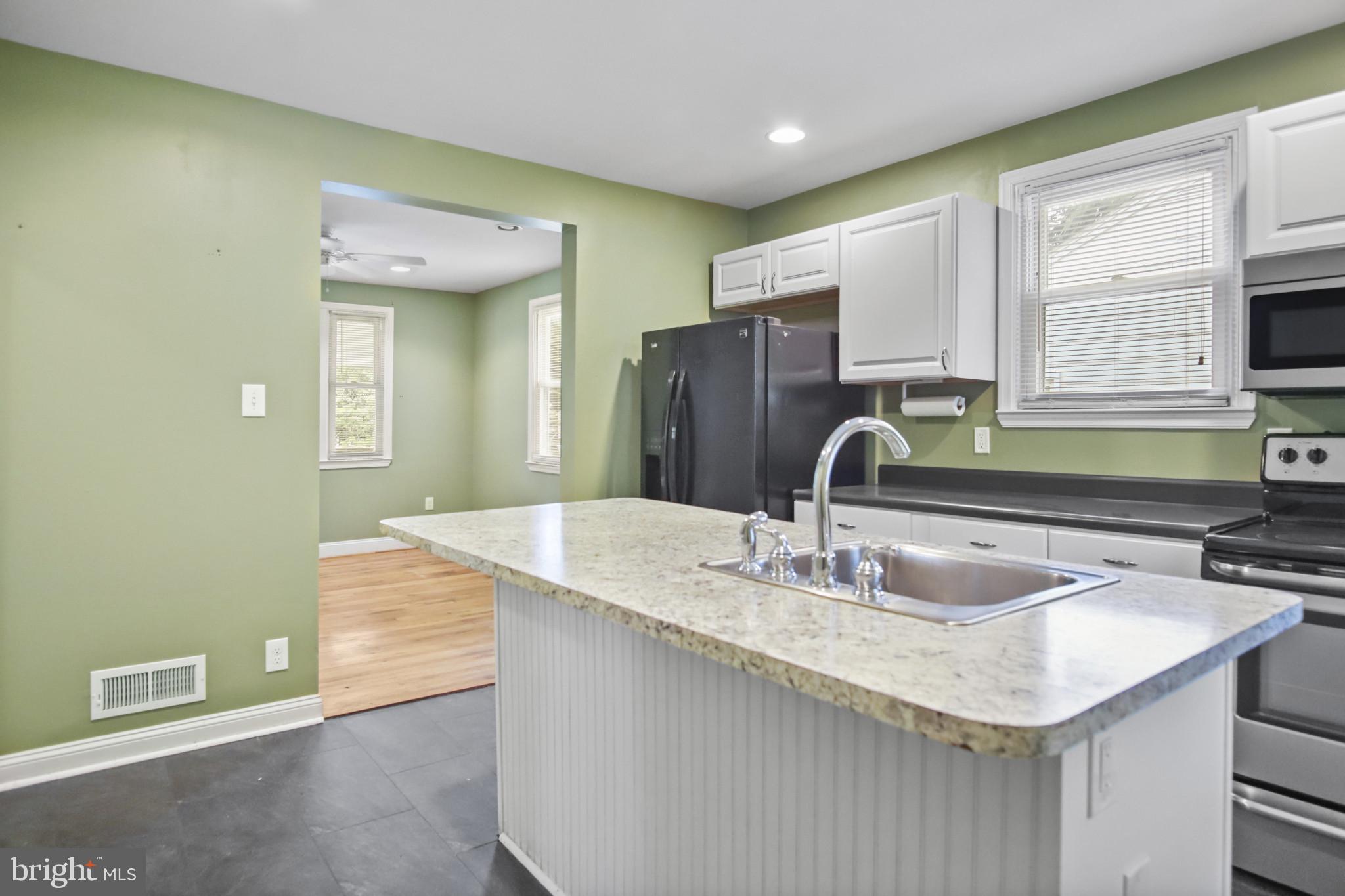 317 Wye Road Essex, MD 21221 - Photo 15 of 35 a kitchen with a sink cabinets and a refrigerator