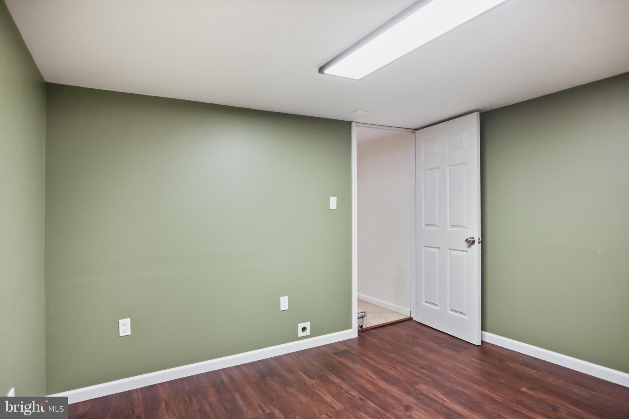 317 Wye Road Essex, MD 21221 - Photo 20 of 35 an empty room with wooden floor and entrance