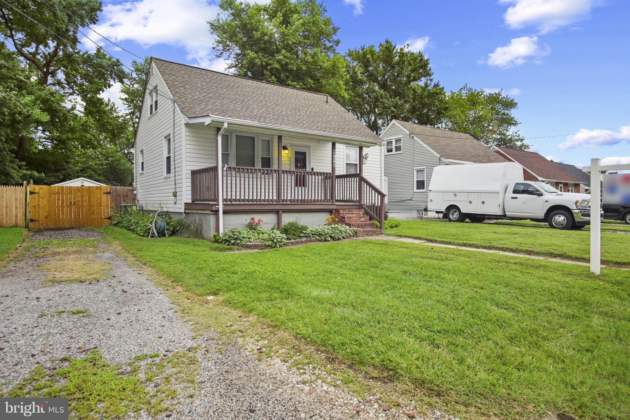 317 Wye Road Essex, MD 21221 - Photo 33 of 35 a front view of a house with a yard and trees