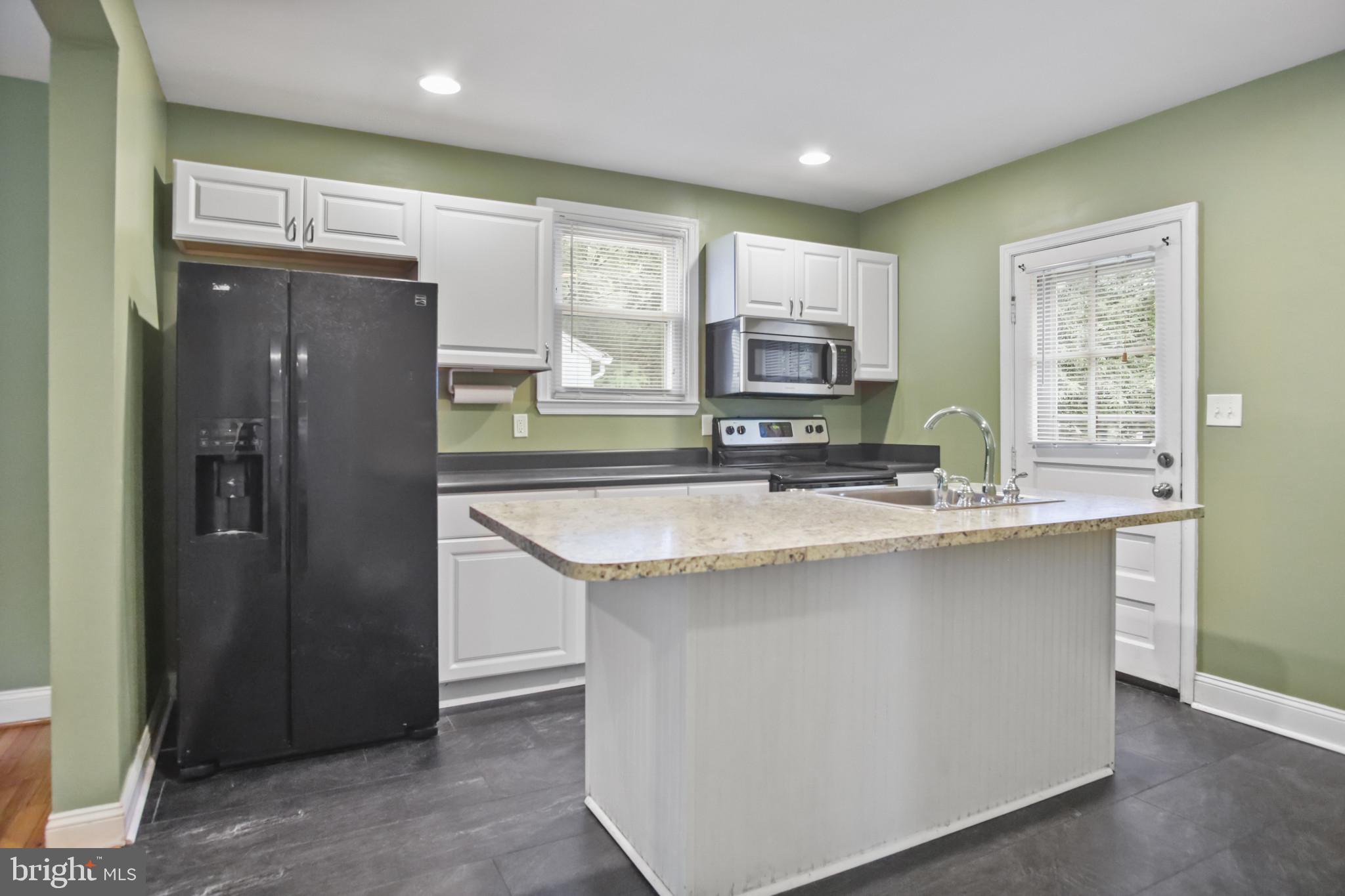 317 Wye Road Essex, MD 21221 - Photo 4 of 35 a kitchen with stainless steel appliances granite countertop a refrigerator and a sink