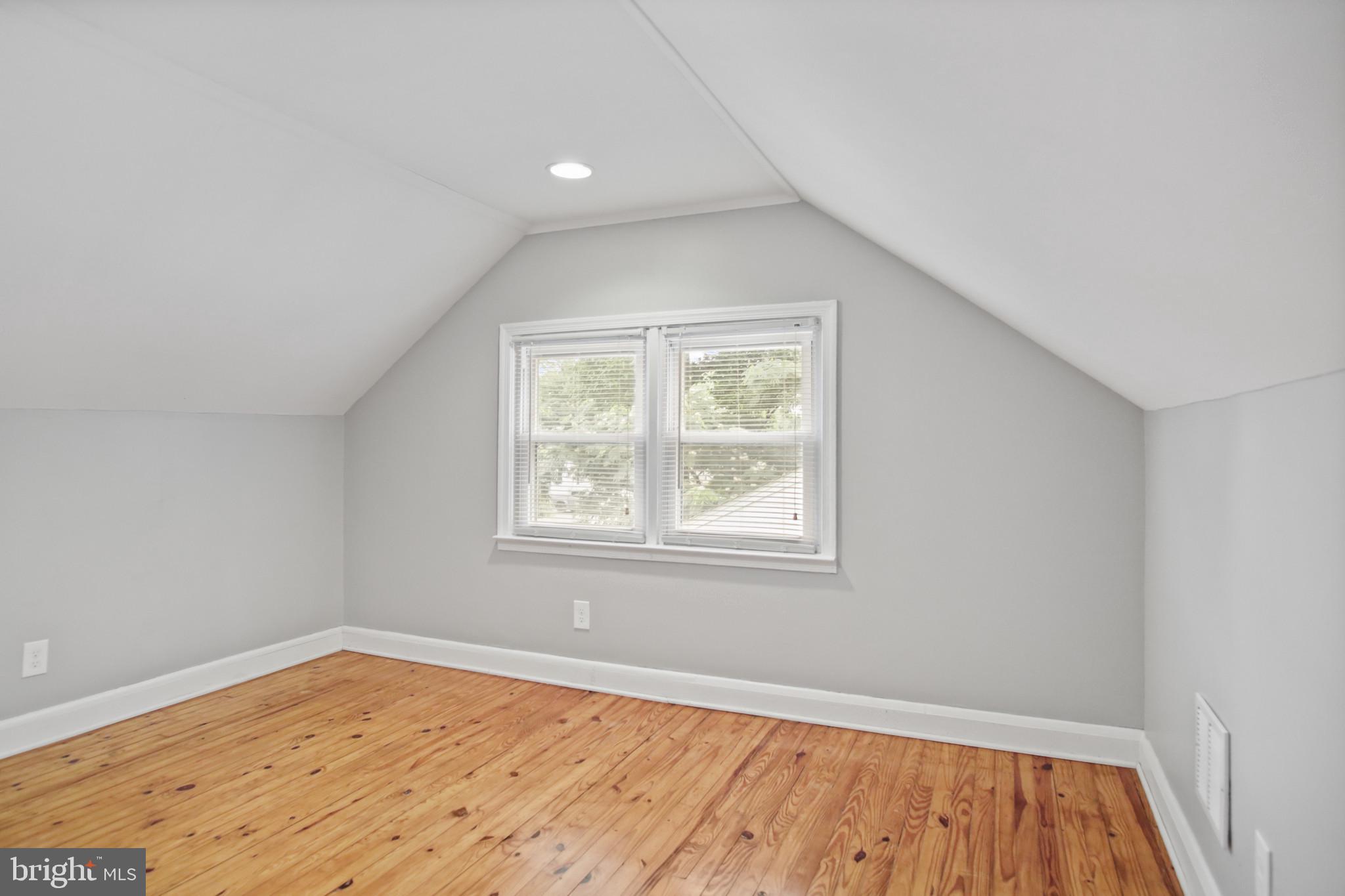 317 Wye Road Essex, MD 21221 - Photo 5 of 35 an empty room with wooden floor and windows