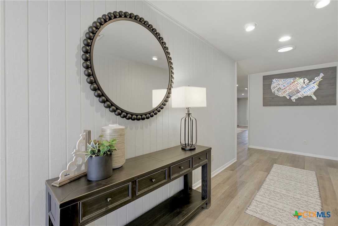 1710 Old Mill Road, Unit 12 Salado, TX 76571 - Photo 4 of 42 a room with painting on the wall and a potted plant