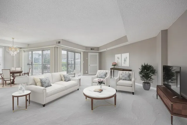 a living room with furniture a large window and a flat screen tv