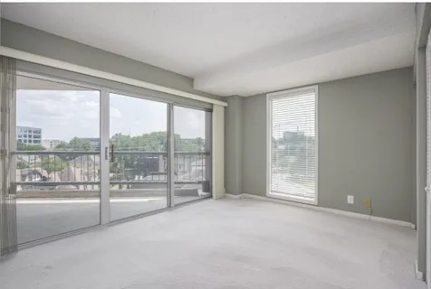 a view of an empty room with windows