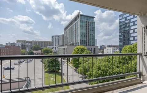 a living room with furniture and large windows