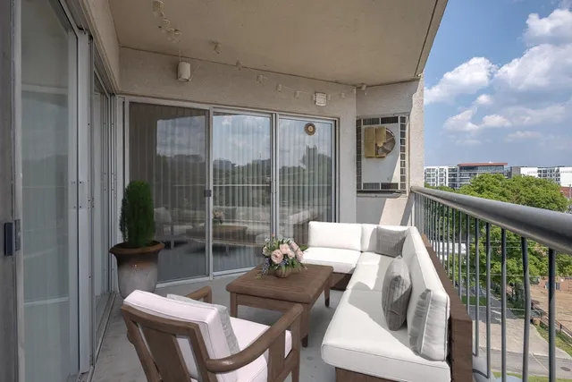 a living room with furniture and a floor to ceiling window