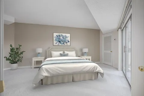 a bedroom with a bed and a painting on the wall