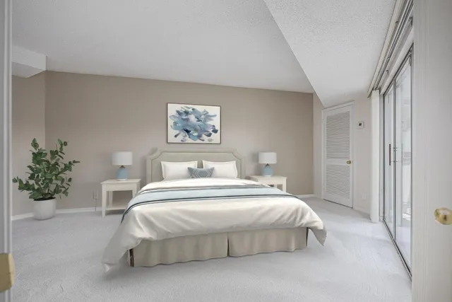 a bedroom with a bed and a painting on the wall