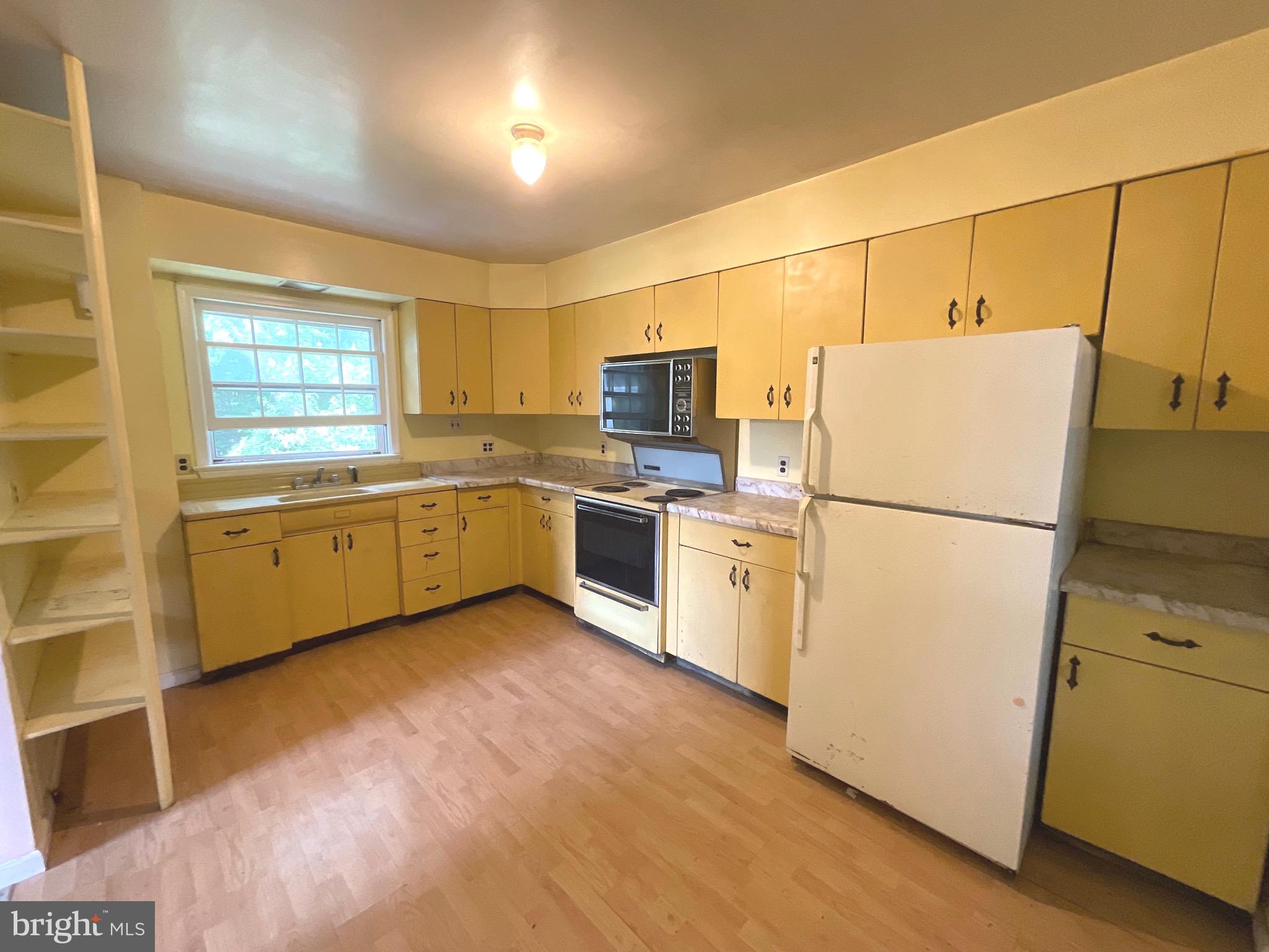 13117 Hazel River Road Rixeyville, VA 22737 - Photo 12 of 32 a kitchen with sink cabinets and white appliances