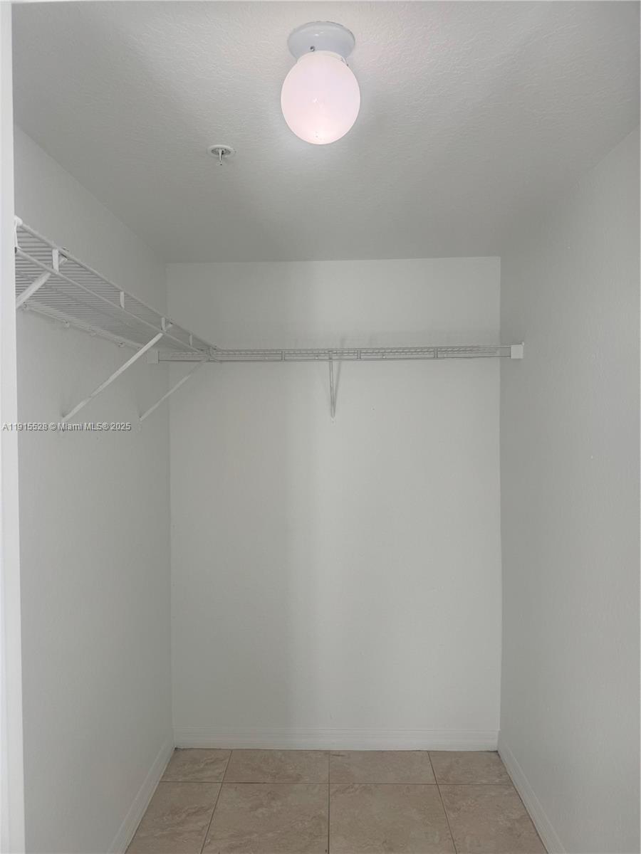 930 Southwest 129th Place, Unit 401 Miami, FL 33184 - Photo 2 of 8 a view of a room with racks on the wall