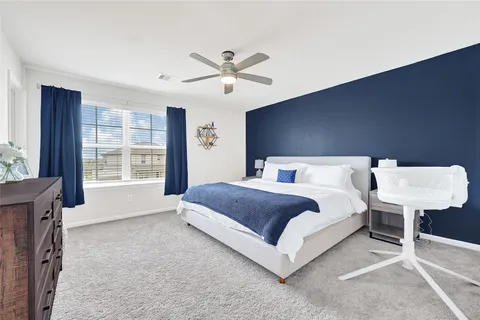a bedroom with a bed and a couch