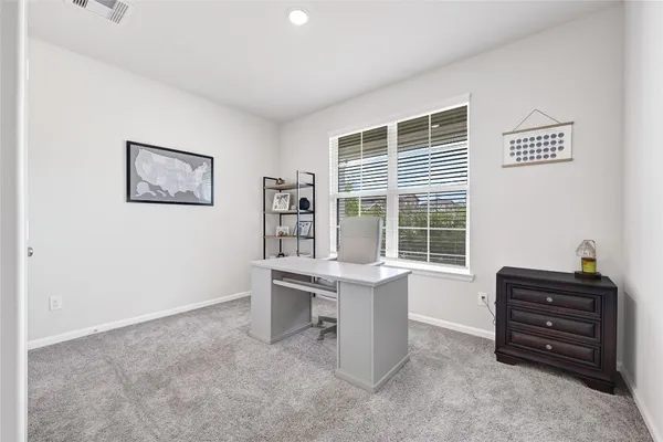 a kitchen with stainless steel appliances granite countertop a stove top oven a sink a dining table and chairs with wooden floor