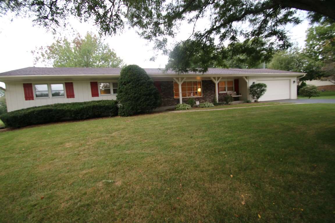 8131 Clockview Road Rockford, IL 61108 - Photo 1 of 25 a front view of a house with garden