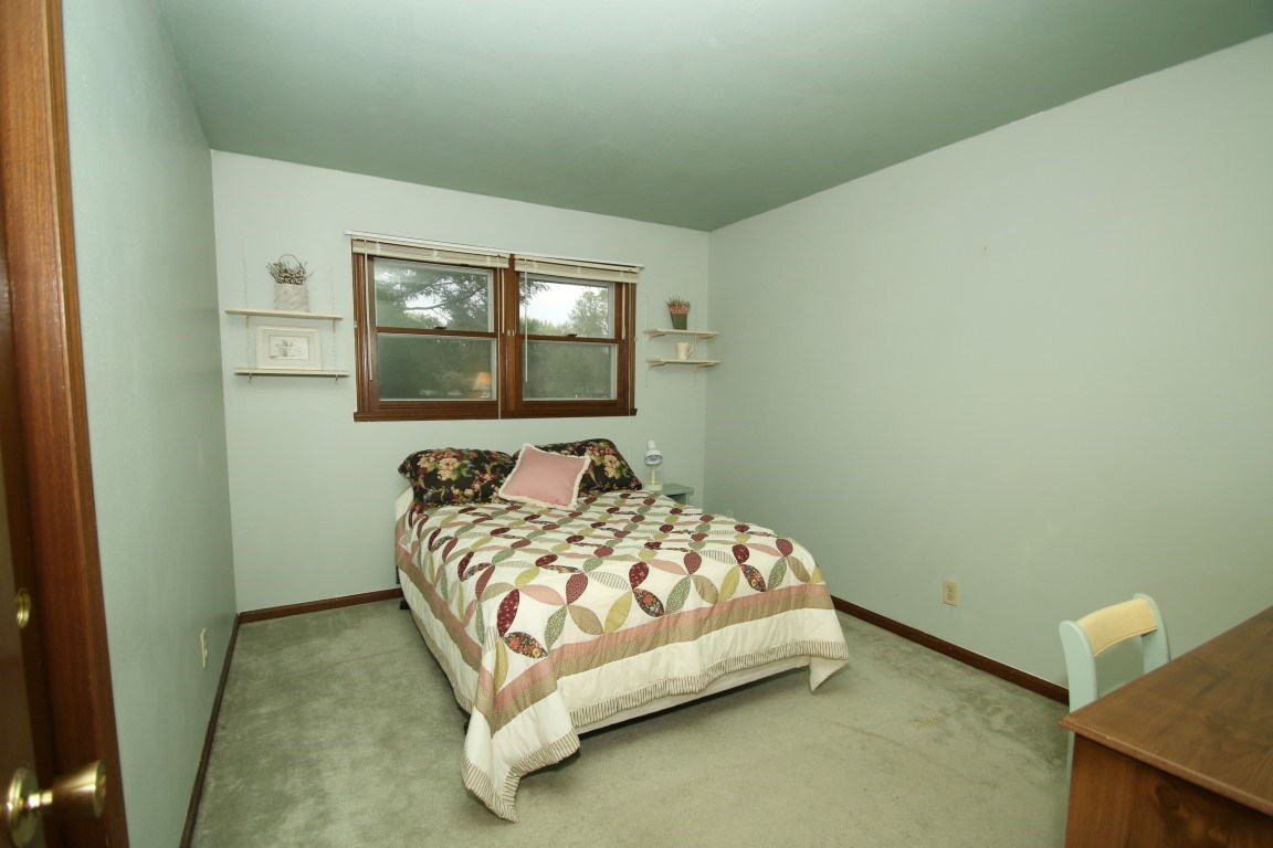 8131 Clockview Road Rockford, IL 61108 - Photo 13 of 25 a bedroom with a bed and window