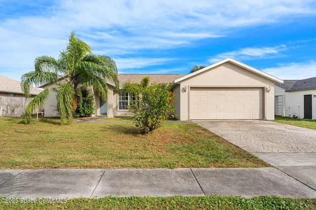 a view of a yard in front of a house with a garage